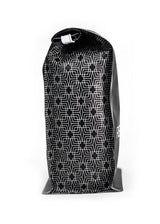 Side view of black and white coffee bag with patterned design